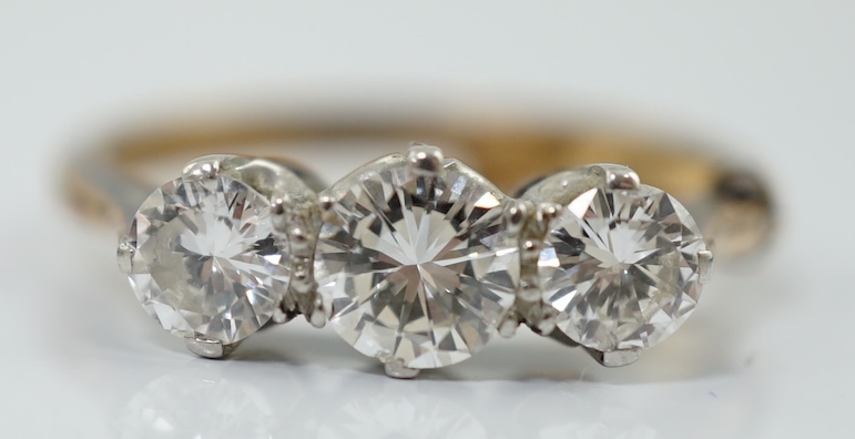 An 18ct gold, platinum and three stone diamond set ring